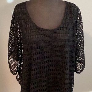 Black woven top with liner. It wears like a poncho. Polyester